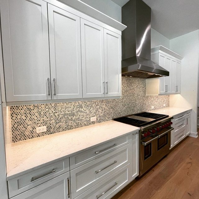 Tile backsplash in hexagon mosaic running the full length of the counter