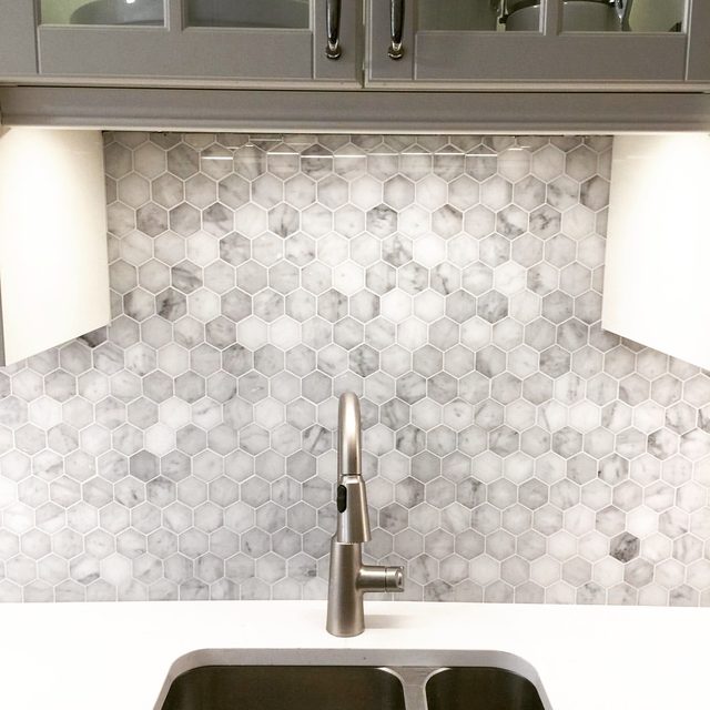 Tile backsplash: marble-look hexagon tile behind a sink