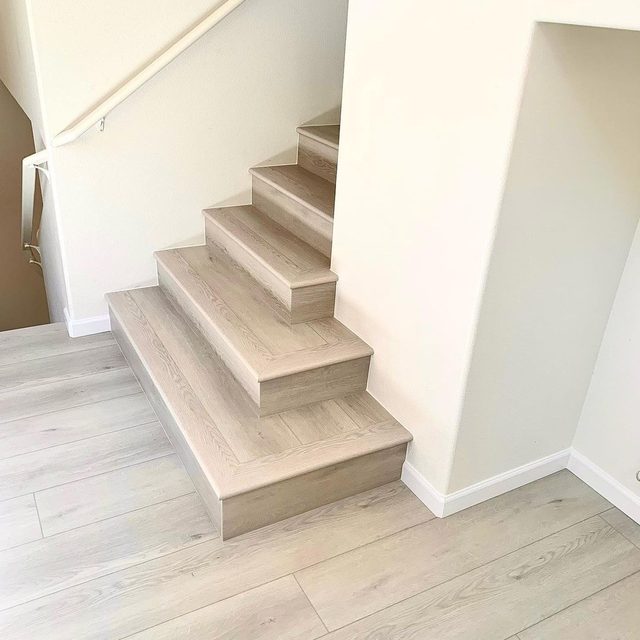 Vinyl plank stairs flowing into a matching vinyl plank floor